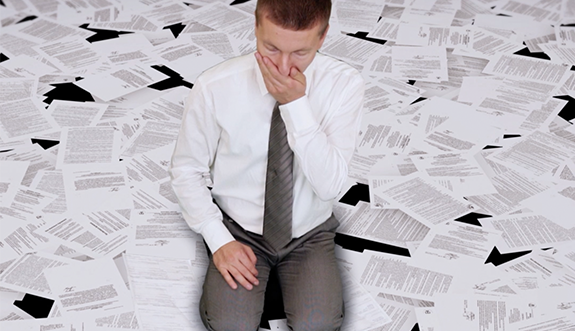 Man surrounded by OREA Exam notes